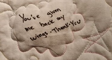 Picture of a quote from our client quilt," You've given me back my wings. Thank you."
