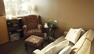 Clinic counselling room with a chair and couch