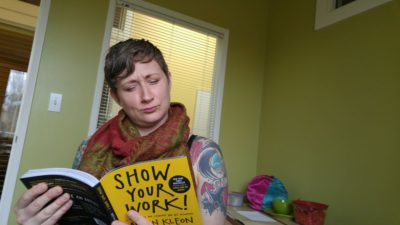 Kara reading a book called, "Show your work!"